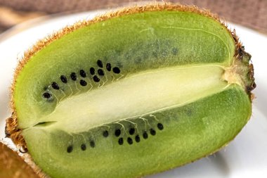 kiwi fruit cut in half on a plate