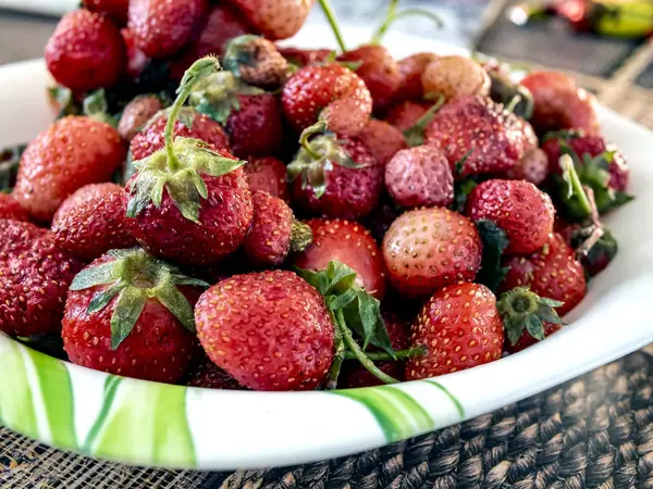 defrosted strawberries on a plate, macro