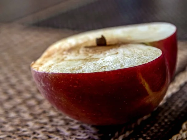 half an Apple cut off in the morning on the table after lunch, macro, narrow focus zone