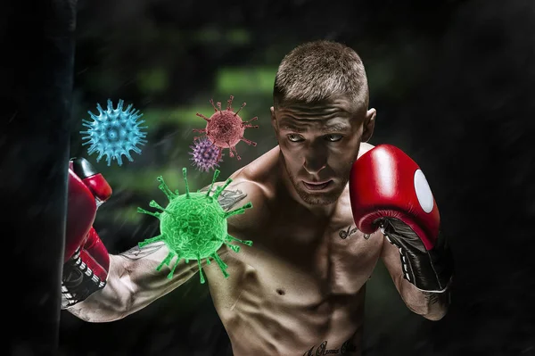 Boxer hits the bag and the coronavirus flies out. Sport vs epidemic. Healthy lifestyle concept. Mixed media