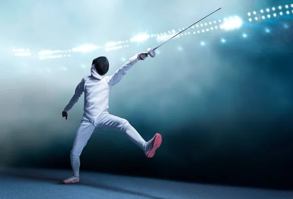 The fencer moves forward with a sword in his hand. Sport concept. Mixed media