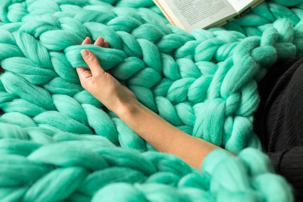 Cozy composition, closeup of woman reading book on merino wool p — Stock Photo, Image