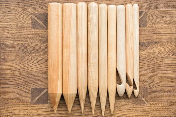 Wooden knitting needles on wooden table Stock Photo by ©riakhinstock  129141152