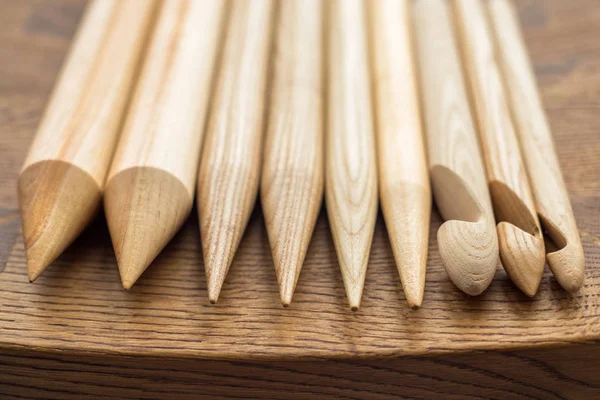 wooden knitting needles on wooden table