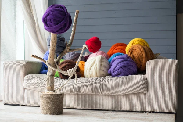 Warm interior with merino wool balls in multicolour on white sof — Stock Photo, Image