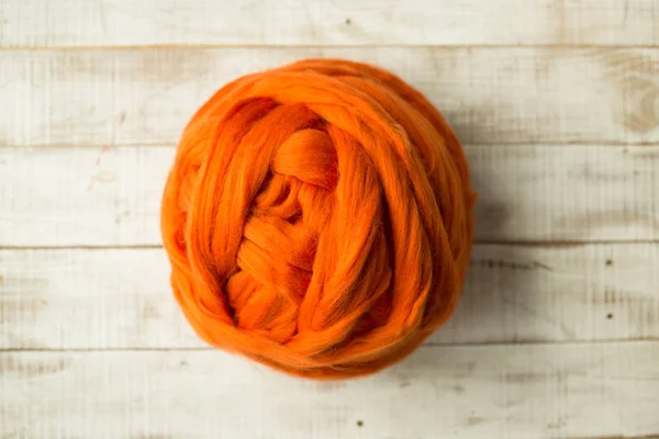 Orange merino wool ball on wooden background — Stock Photo, Image