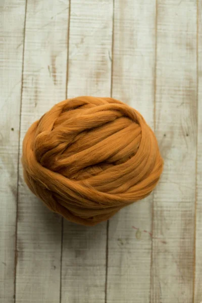 Brown merino wool ball on wooden background — Stock Photo, Image