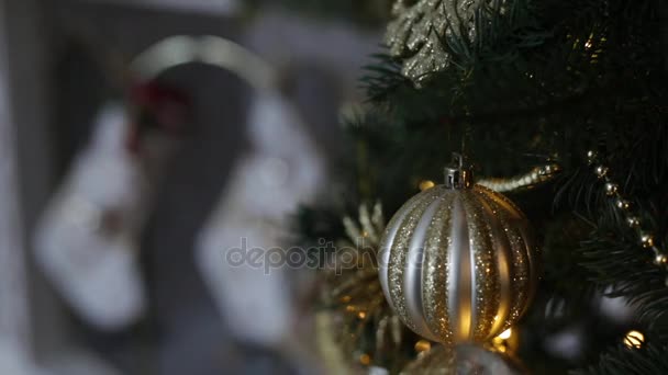 Christmas tree closeup and fire in fireplace on background. — Stock Video