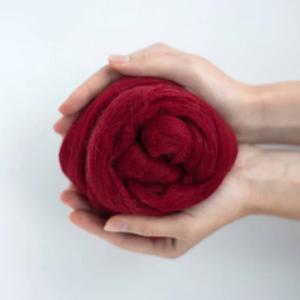 Close-up of bordeaux merino wool ball in hands — Stock Photo, Image
