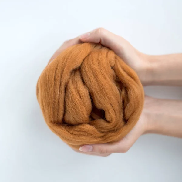 Close-up of brown merino wool ball in hands — Stock Photo, Image