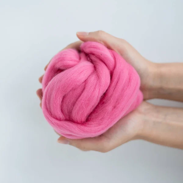 Close-up of pink merino wool ball in hands — Stock Photo, Image