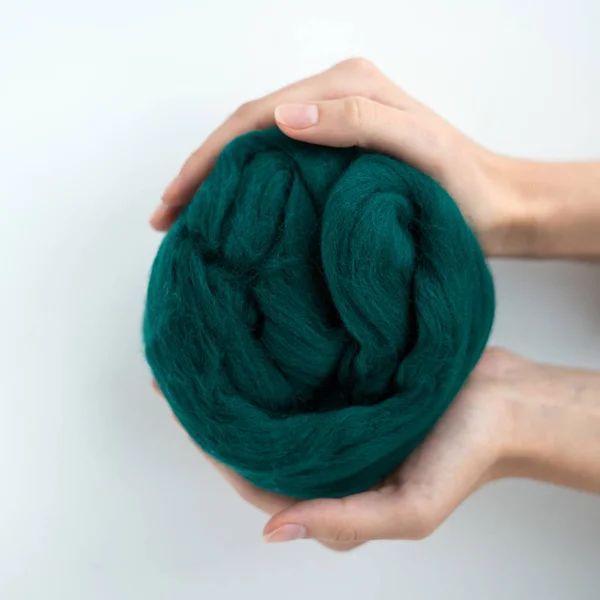 Close-up of grey merino wool ball in hands — Stock Photo, Image