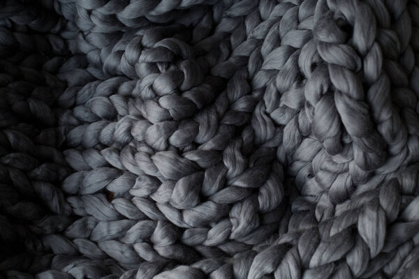Close-up gray knitted blanket, merino wool background