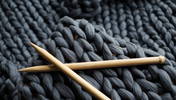 Wooden knitting needles on background of grey merino — Stock Photo, Image