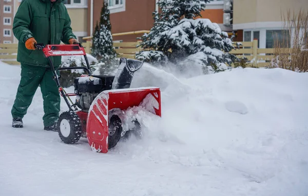 Man working with a snow blowing machine — Stock Photo, Image