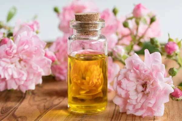 Gül uçucu yağ küçük gül çiçekleri ile bir şişe