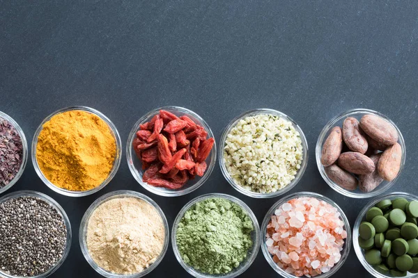 Selection of superfoods on a black background with copy space — Stock Photo, Image