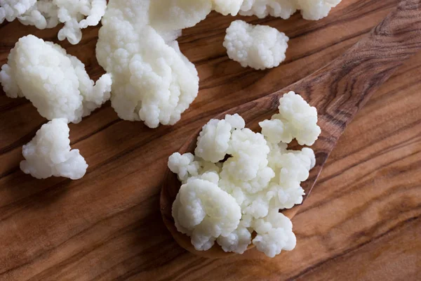 Granos de kéfir de leche sobre fondo de madera —  Fotos de Stock