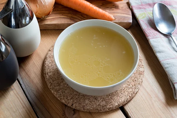 Bone broth made from chicken served in a soup bowl — Stock Photo, Image