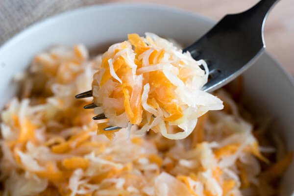 Fermented cabbage and carrots on a fork