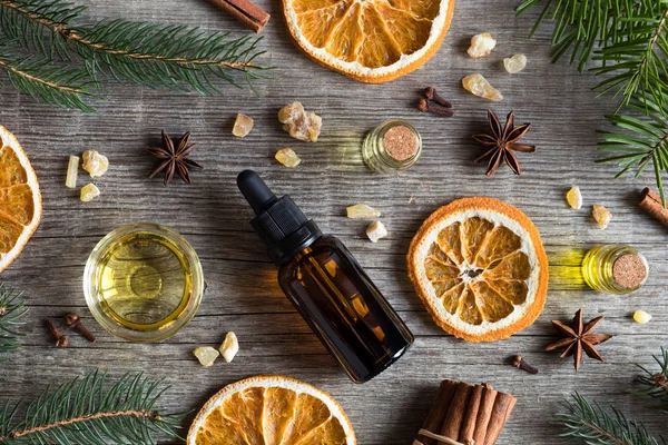 Selection of essential oils with Christmas spices and ingredient