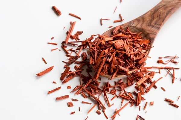 Sandal ağacı parçalar üzerinde beyaz zemin üzerine bir tahta kaşık