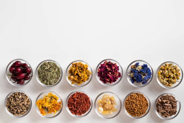 Selection of dried herbs on a white background with copy space, top view — Stock Photo, Image