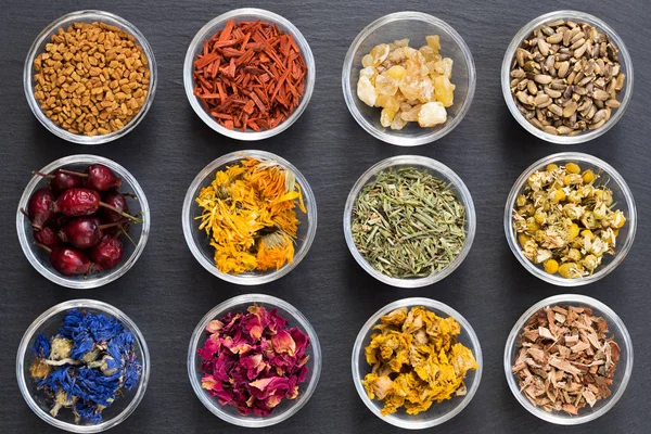 Selection of dried herbs on a dark background, top view — Stock Photo, Image