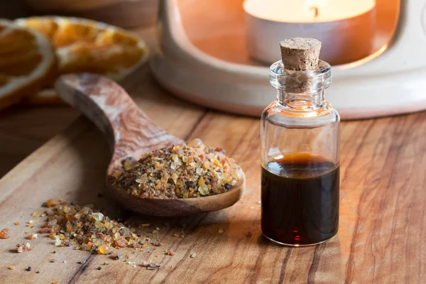 A bottle of myrrh essential oil with myrrh resin and an aroma la — Stock Photo, Image