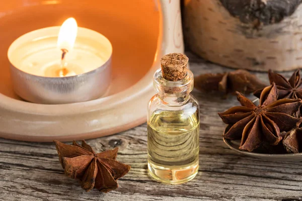 A bottle of star anise essential oil with star anise — Stock Photo, Image