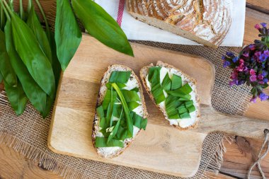 Two slices of sourdough bread with butter and wild garlic clipart