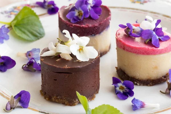 Raw vegan desserts with fresh violet flowers