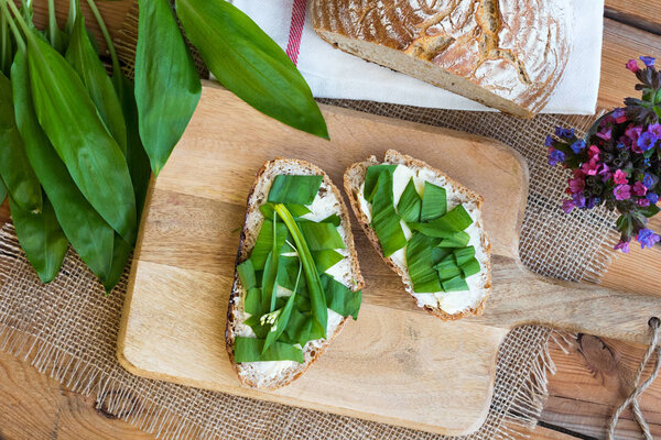 Two slices of sourdough bread with butter and wild garlic