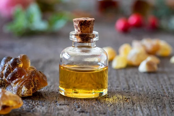 A bottle of frankincense essential oil with frankincense resin c — Stock Photo, Image