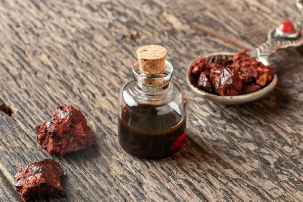 A bottle of  sangre de drago oil with Croton lechleri resin on a — 스톡 사진