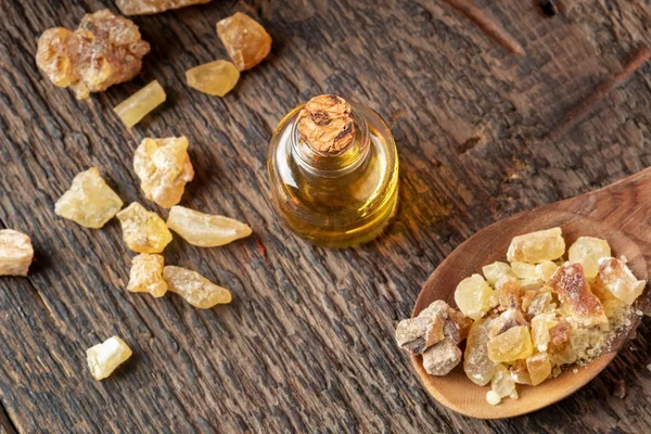 A bottle of frankincense essential oil with frankincense resin — Stock Photo, Image