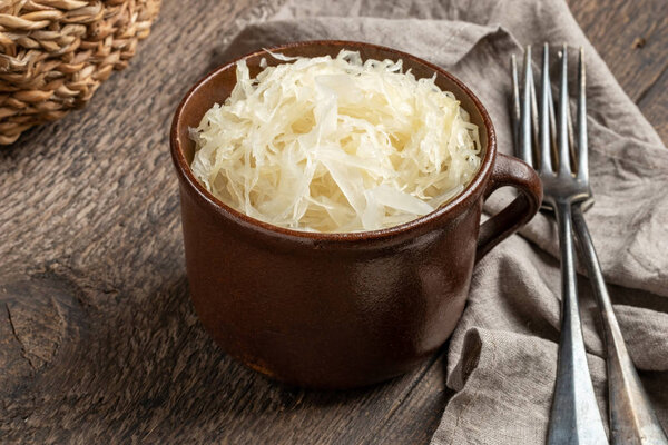 Fermented cabbage in a pot on a table