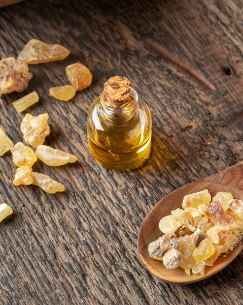 A bottle of frankincense essential oil with frankincense resin — Stock Photo, Image