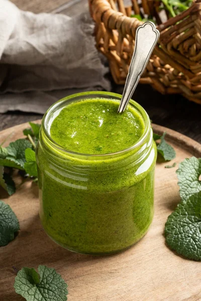 Pesto made from young leaves of garlic mustard or Alliaria petiolata - a wild edible plant growing in early spring