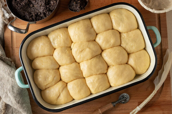 Buchty, traditional Czech sweet buns made of yeast dough, rising in a pan before being baked