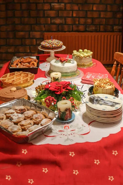 Christmas desert table with red cloth. — Stock Photo, Image