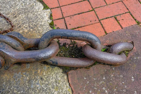 Large rusty link industrial chain close-up.