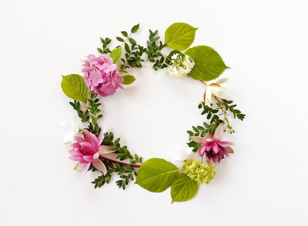 round frame with blooming flowers and leaves on white background
