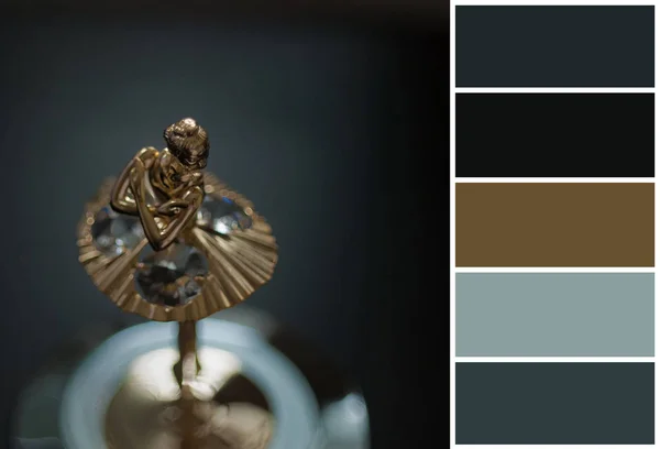 Top view of ballerina statuette on music box. color palette scheme with complementary swatches. Dark photo, grain aded.
