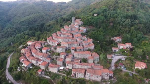 Εναέρια πυροβόλησε, πανέμορφο κλασικό μικρό ιταλικό χωριό της ανισόπεδης διάβασης αυτοκινητόδρομου λόφο, στη μέση του το πράσινο της φύσης — Αρχείο Βίντεο