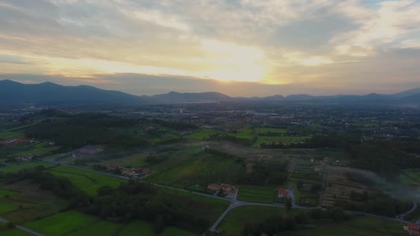 Aerial shot, gorgeous landscape on the sunset, smoke in the middle, in the middle of the plain, made with drone — Stock Video