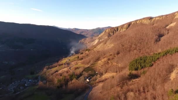 Aerial shot, autumn landscape in the high mountains with coniferous wood, sun going down, filmed with drone — Stock Video