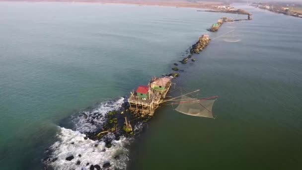 Aerial shot, fishermen house with the huge net in font of it, in Tuscany, Italy, filmed with drone — Stock Video