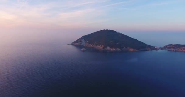 Luchtfoto van prachtige eilandje op zonsondergang met zeer kalme zee in Toscane, Italië, 4k — Stockvideo