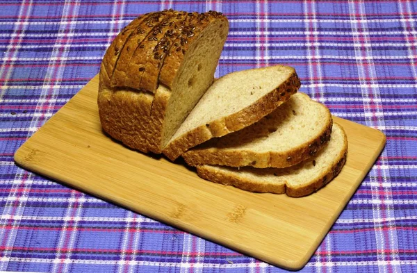 Wheat bread products are on blue tartan — Stock Photo, Image
